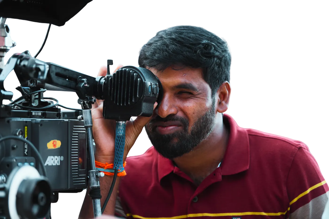 Jai Jnana Prabha Thota looking through the viewfinder of an ARRI film camera